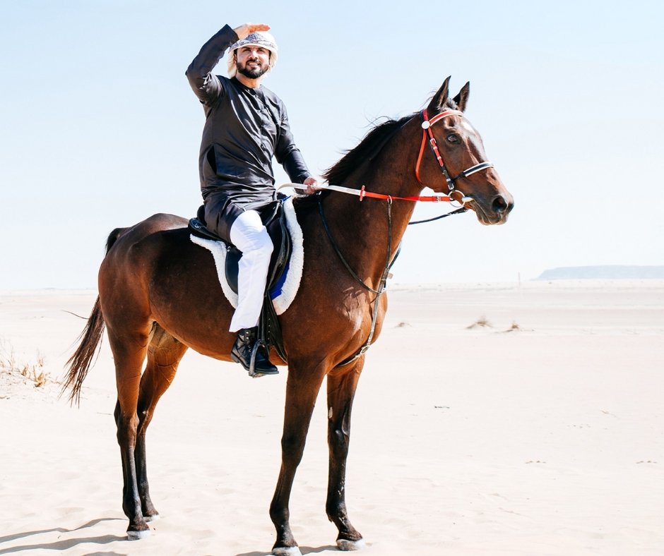 Farrier wearing a waterproof apron while trimming hooves in the rain